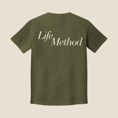 Back of the Life Method Army Green tee with a large cream Life Method script across the upper back
